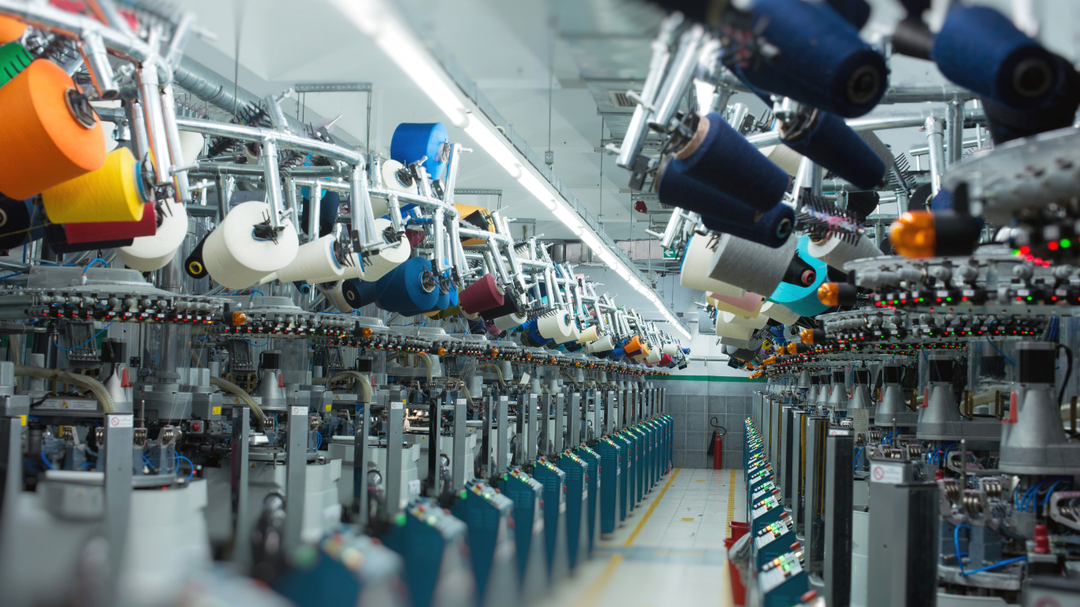 Textile production line with various machines and equipment in a factory setting